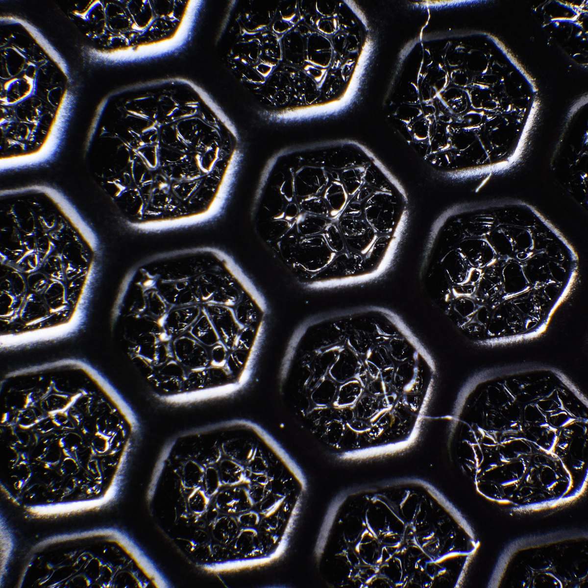 ornament macro photography of gray honeycomb surface black
