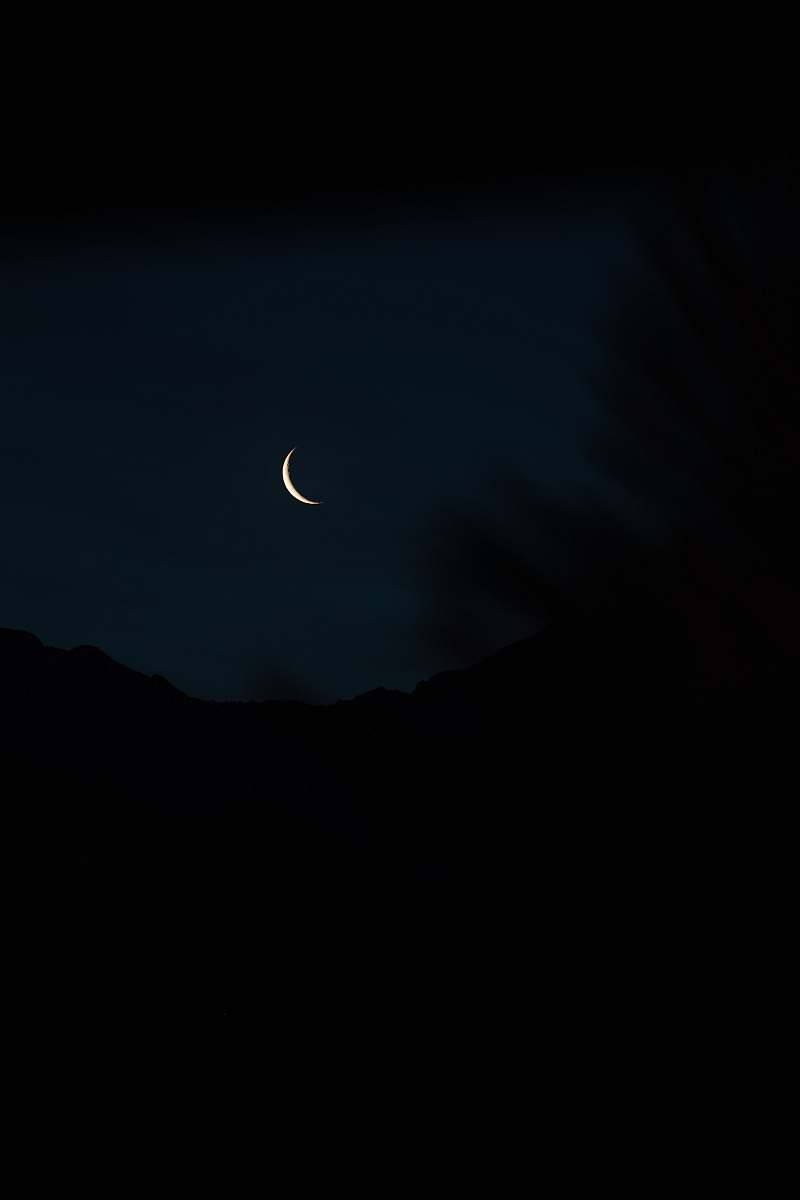 black crescent moon at night outdoors