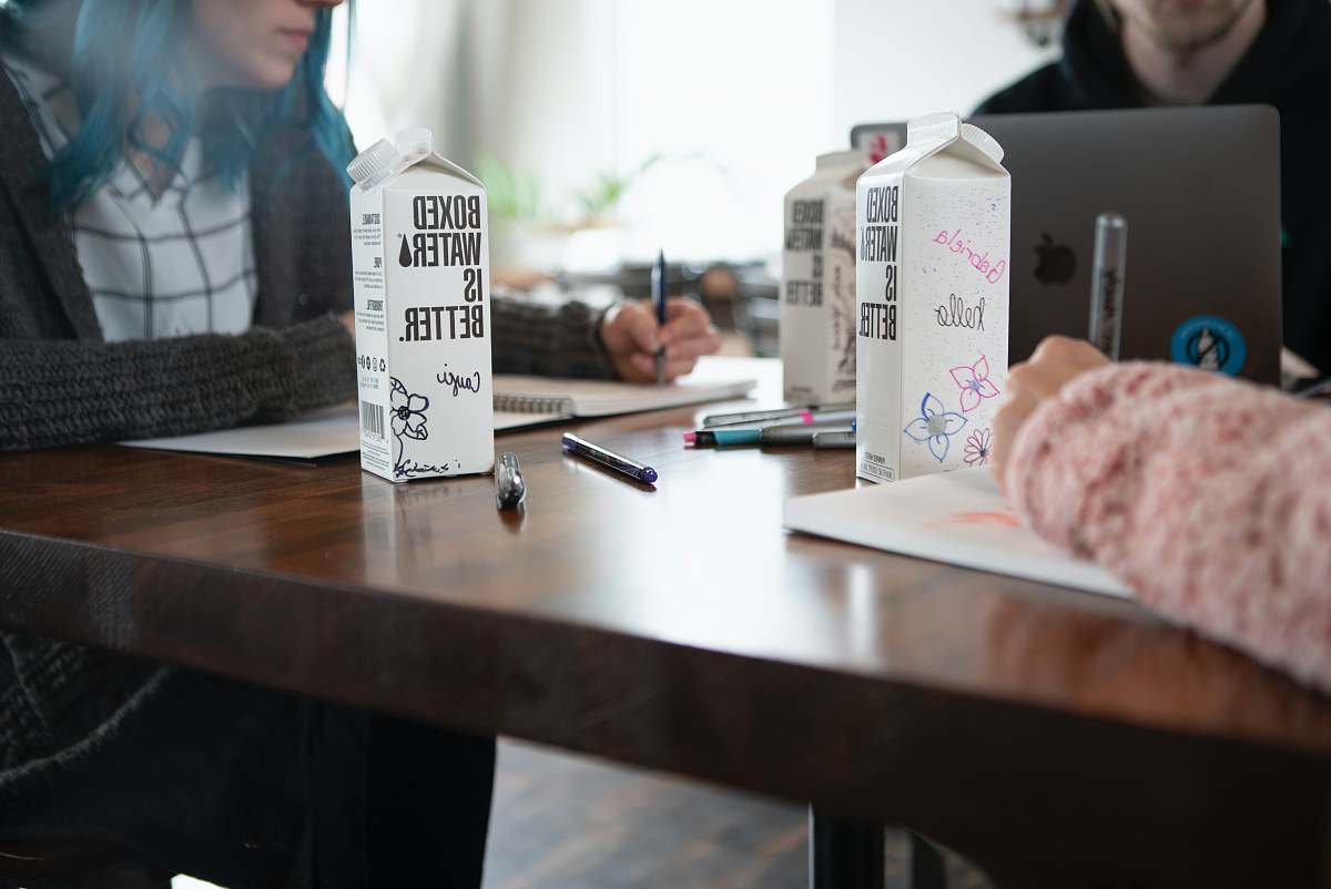 table white carton box on brown wooden table human