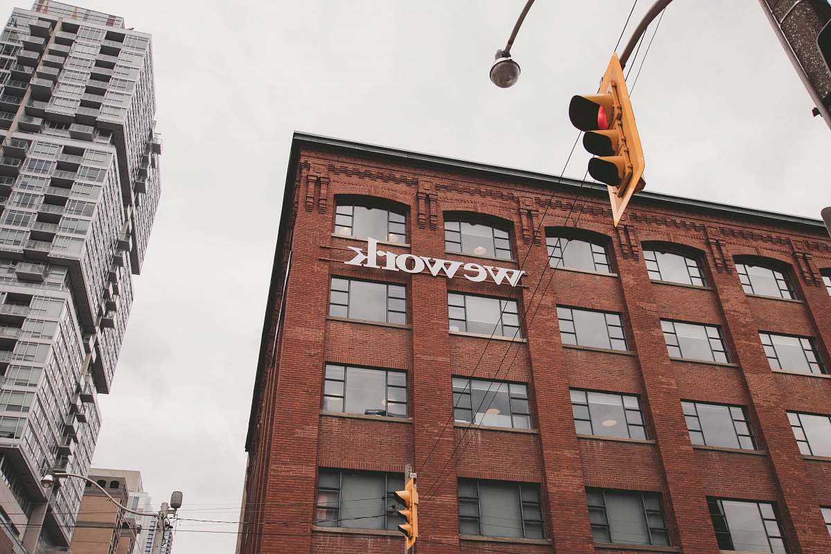 city Wework building beside traffic light during daytime urban