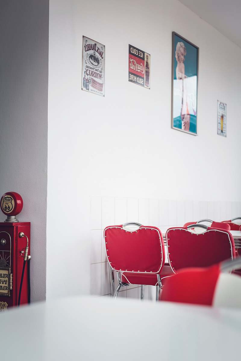 furniture empty chairs beside wall with posters and signs interior design