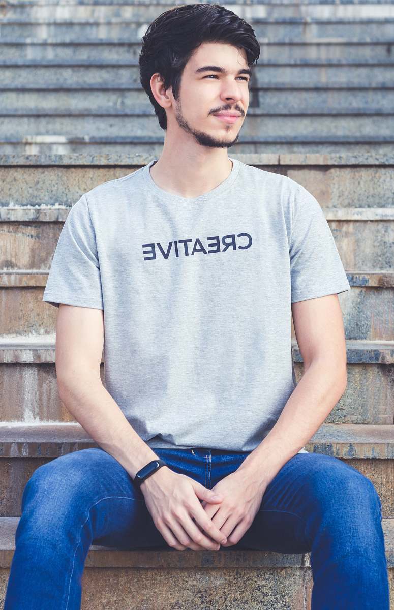 apparel man sitting on concrete stairs pants