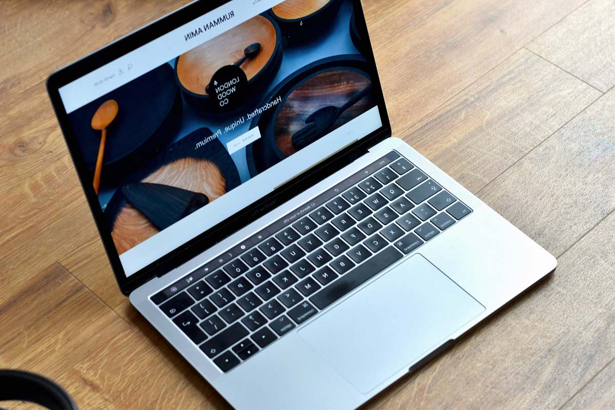 electronics MacBook Pro turned-on on brown wooden surface pc