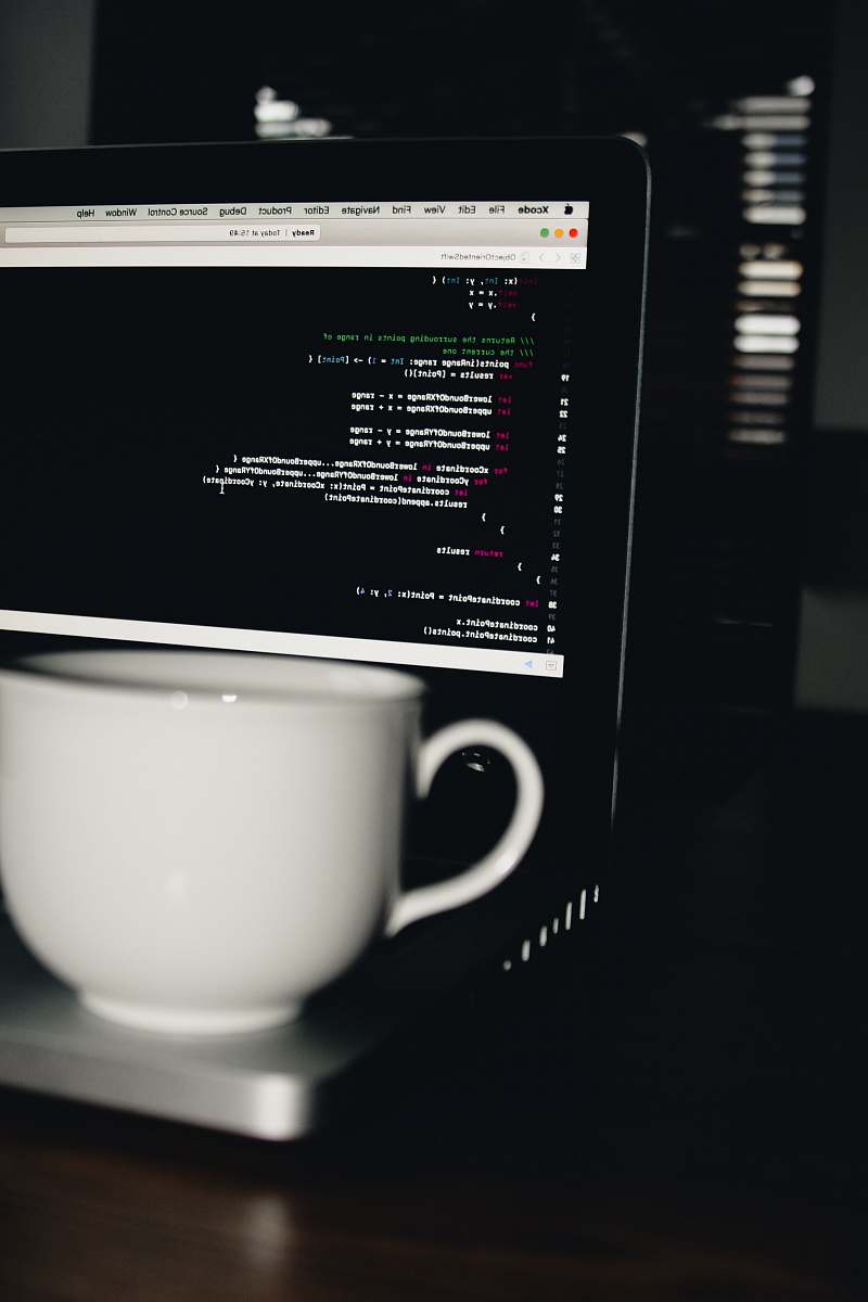 laptop photo of white ceramic teacup on turned on MacBook Pro computer