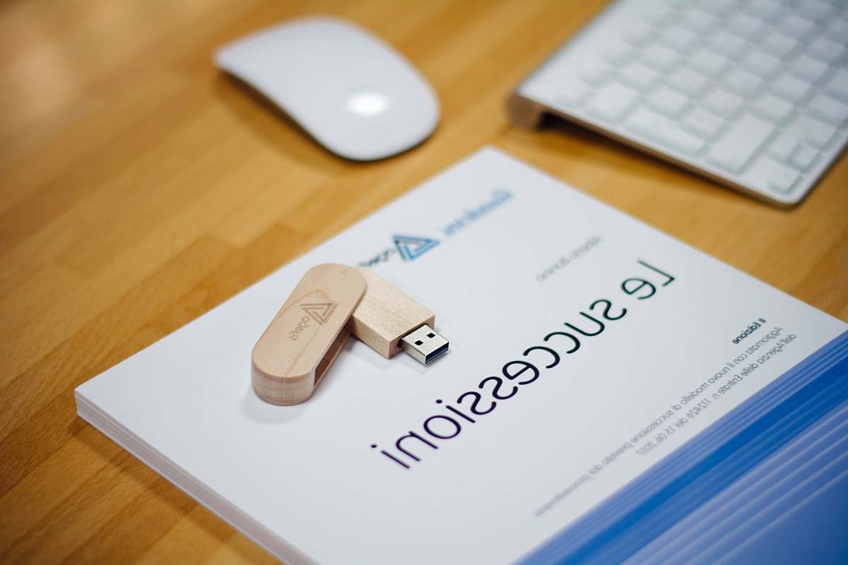 computer brown thumb drive near Apple Magic Mouse and Keyboard hardware