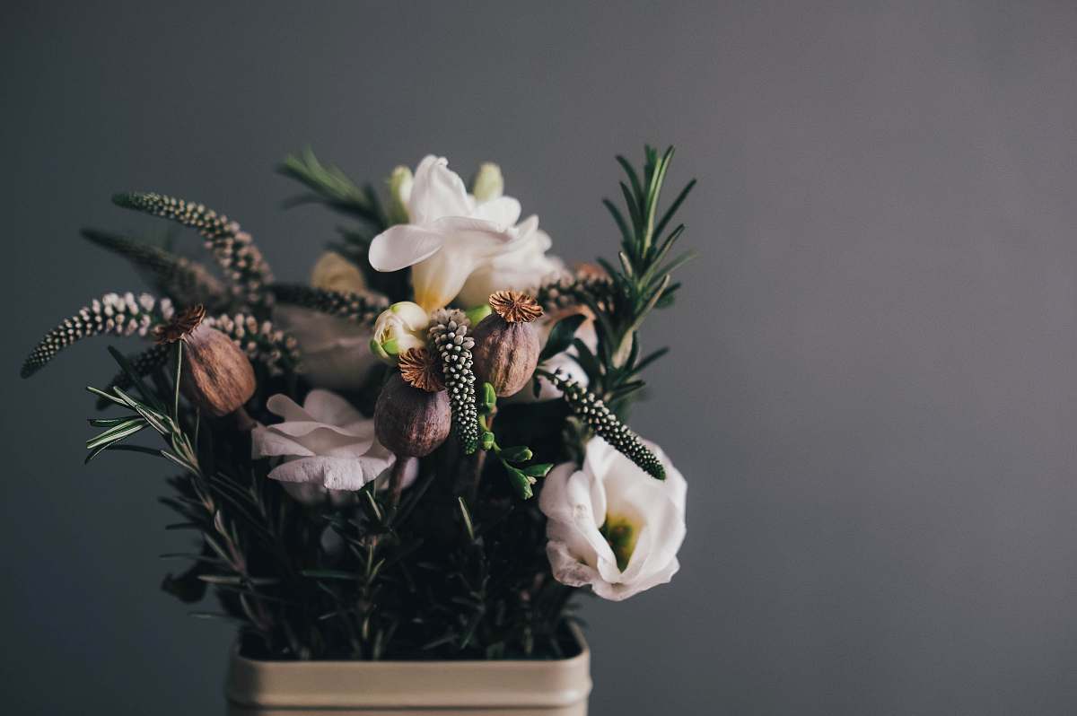floral white petal flowers in gray pot in room flower arrangement
