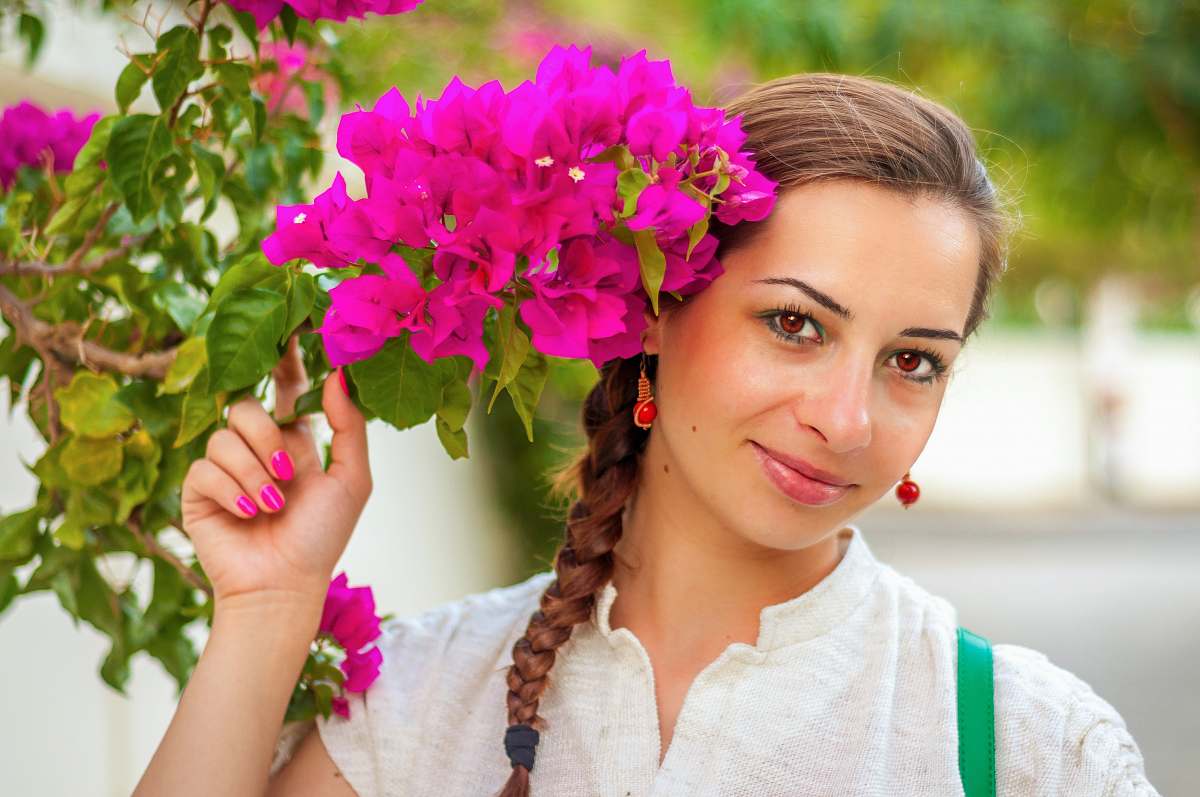 blossom woman wearing white top holding pink flower human