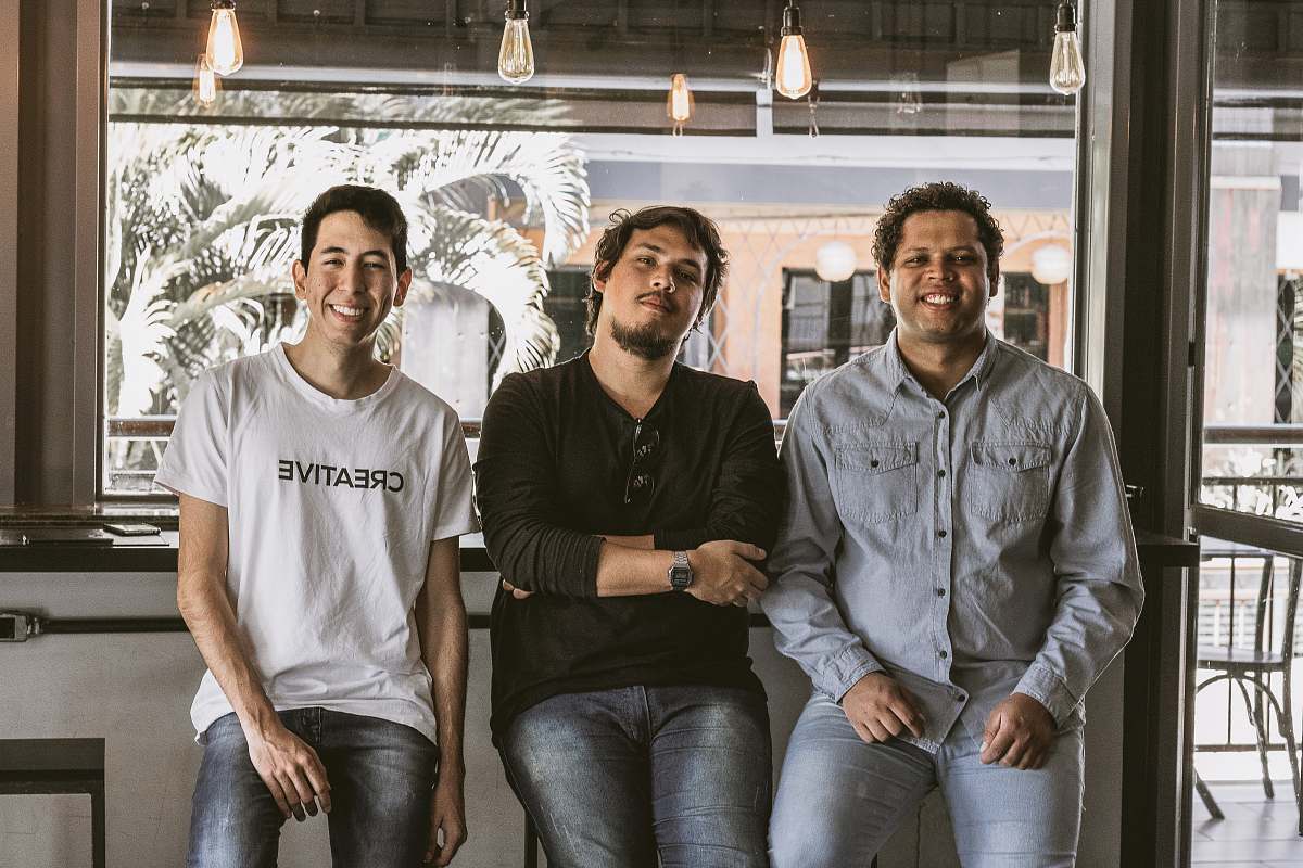 person three sitting men near door pants