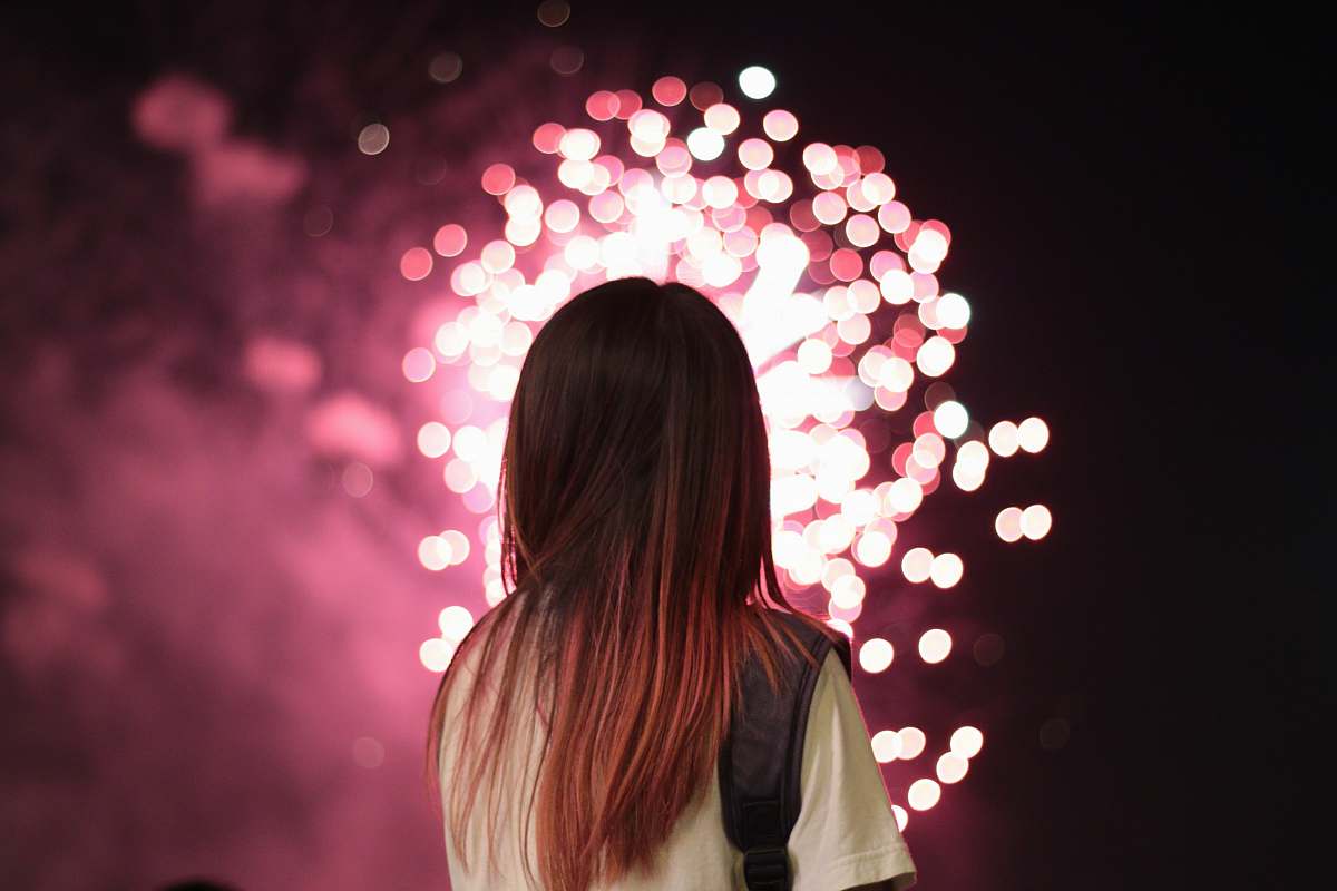 person woman staring at fireworks people