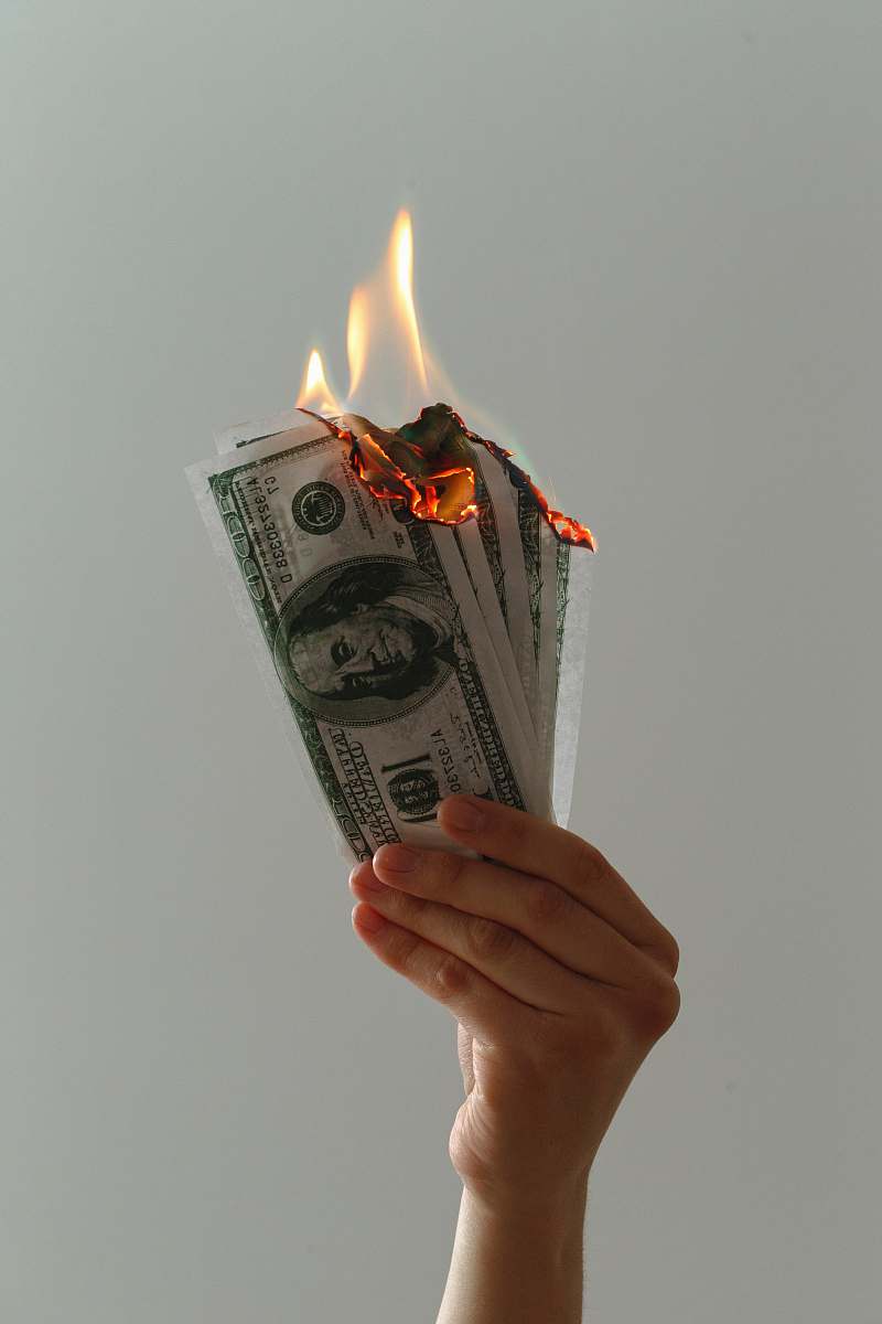 dollar time lapse photography of several burning US dollar banknotes fire