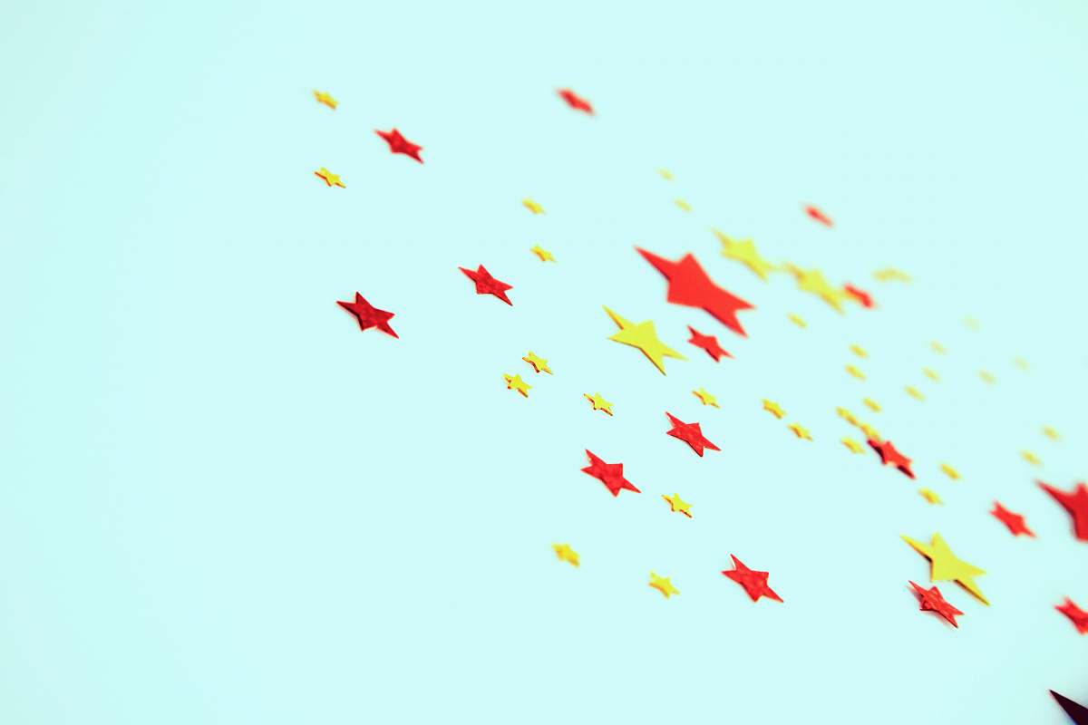 confetti red and yellow stars bird