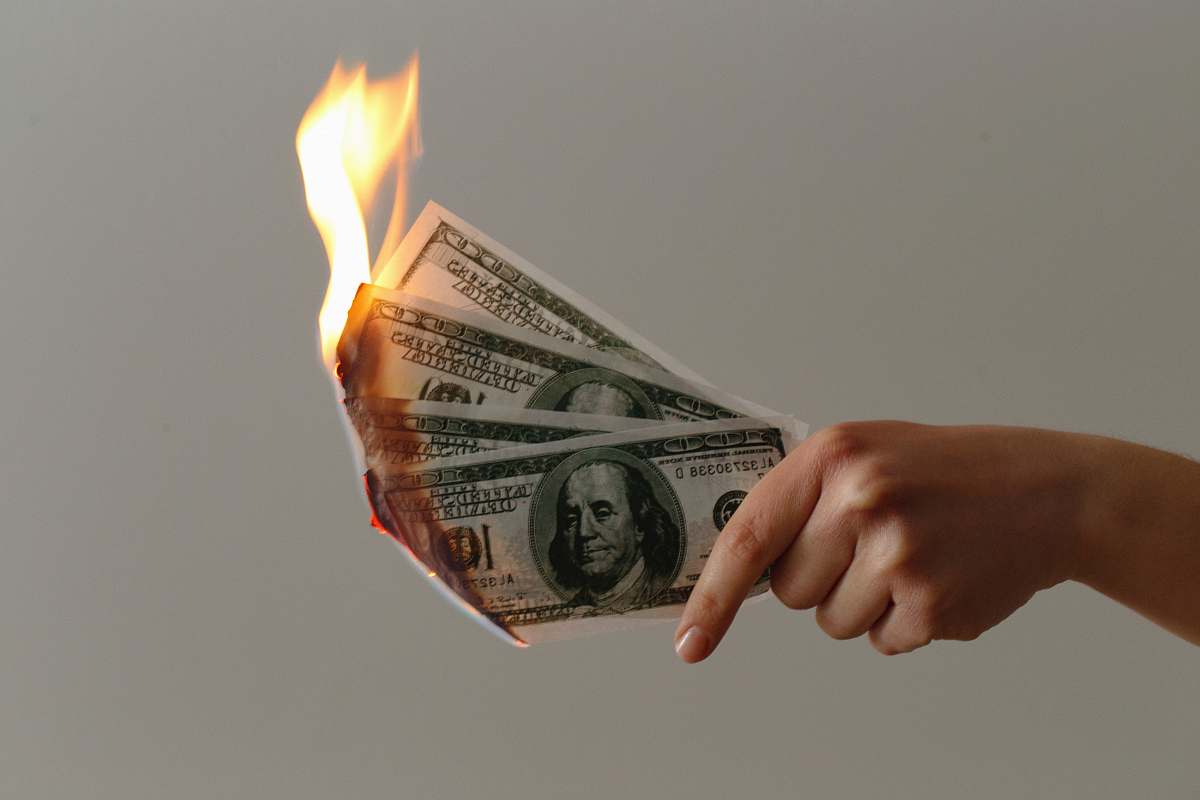 human burned 100 US dollar banknotes money