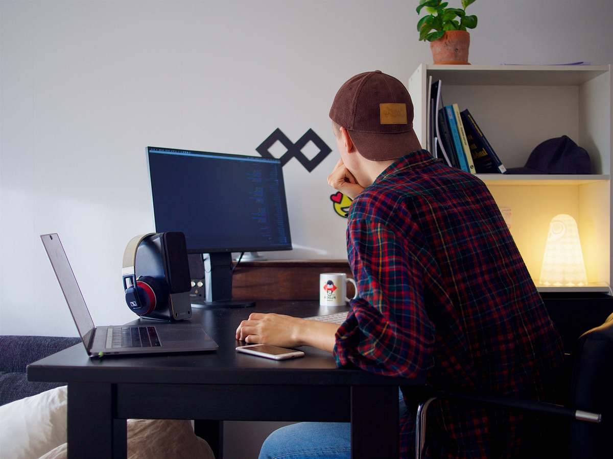 human man in front of desktop furniture