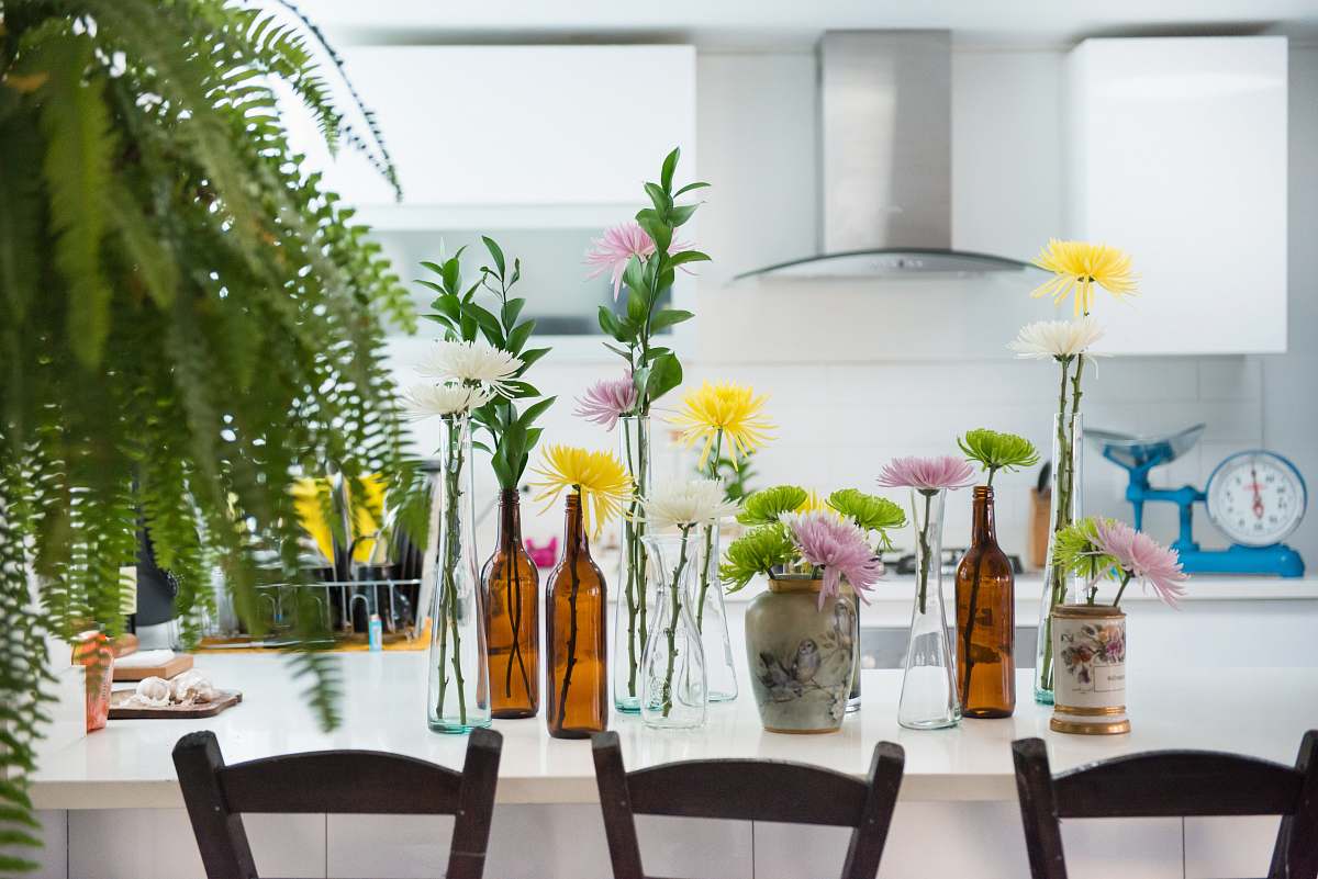 vase green leafed plants on top of white wooden table interior design