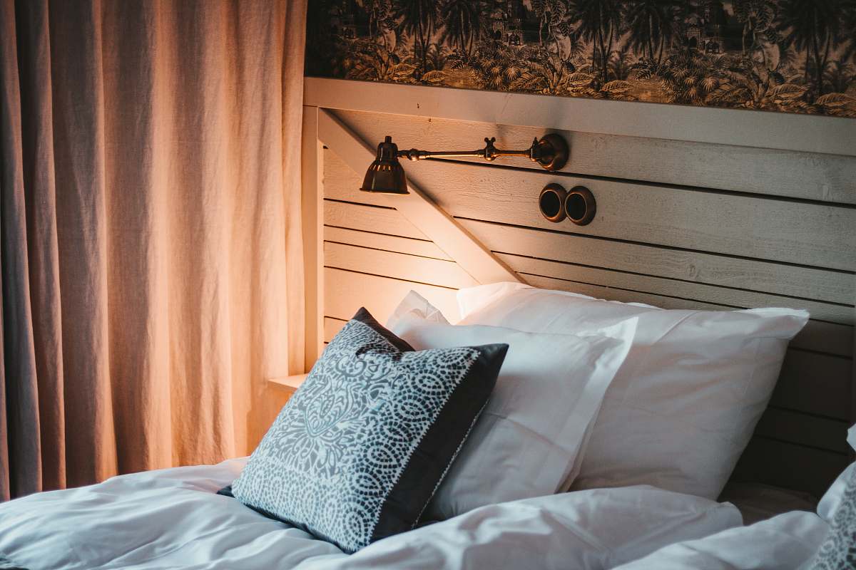 bunn empty bed beside white curtain sweden