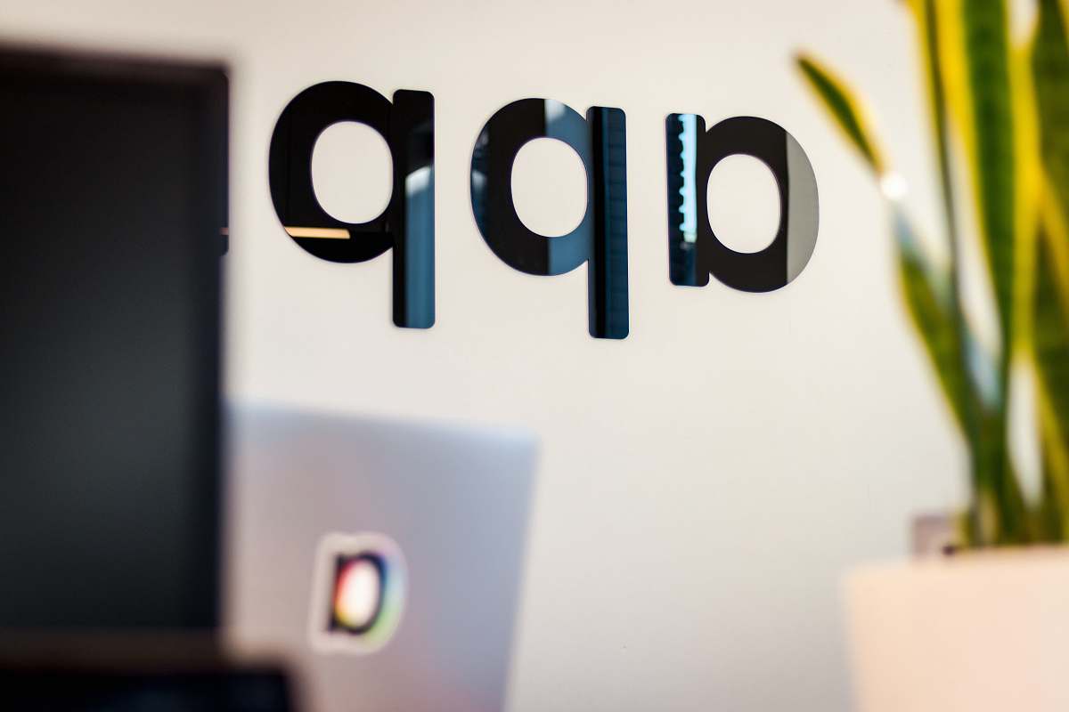 word black app sign on white wall launch cafe