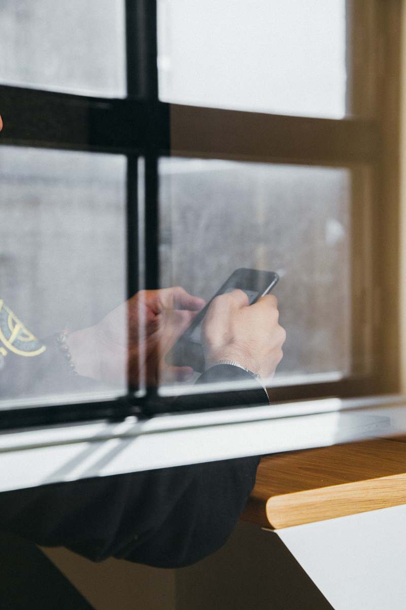 device man holding black Android smartphone meeting