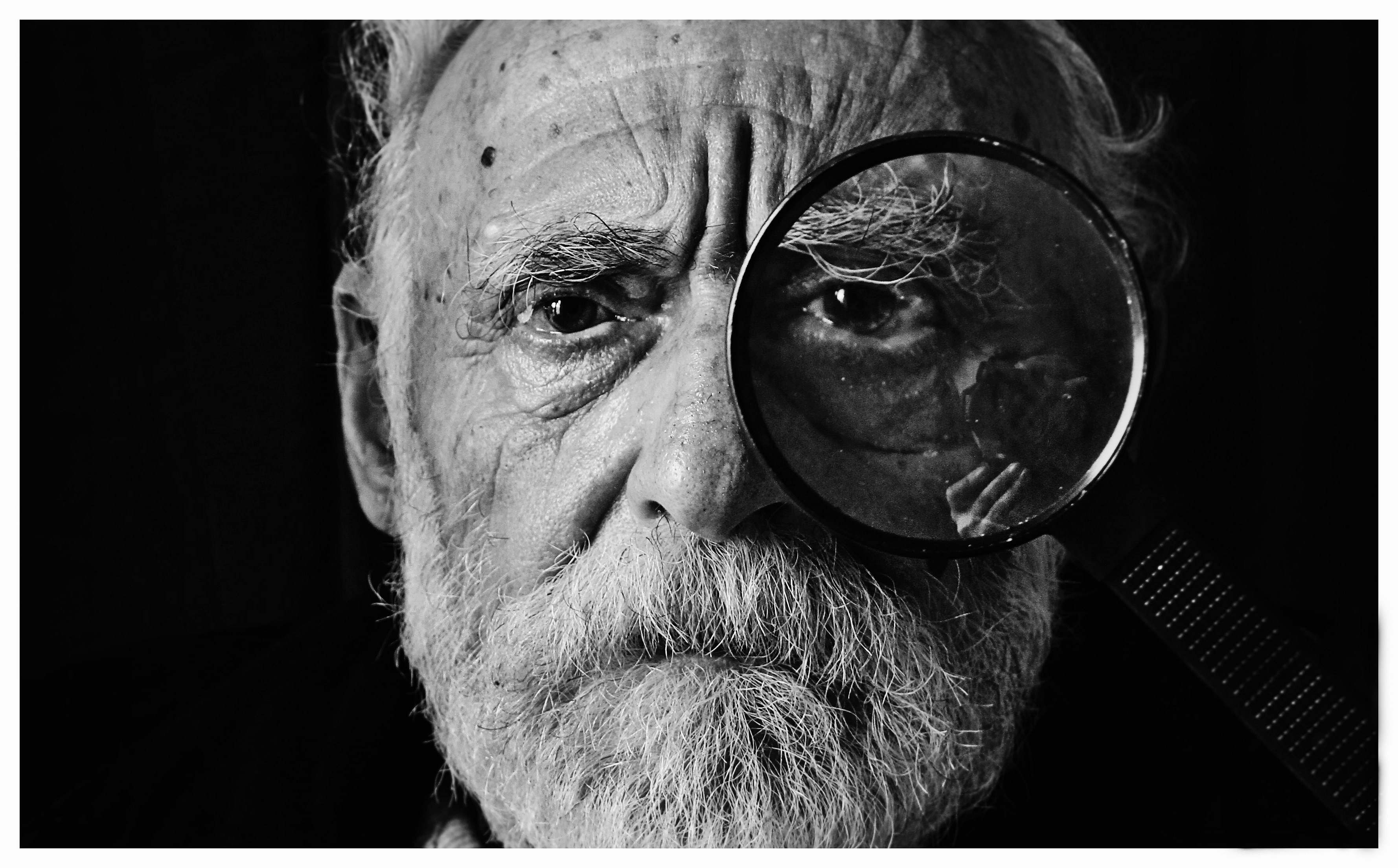 portrait grayscale photo of man using magnifying glass old man Image ...