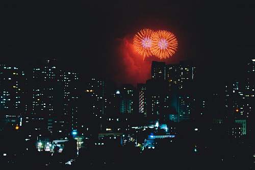 night high-rise buildings and fireworks display outdoors