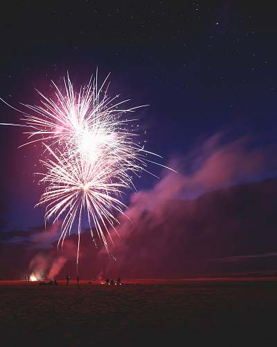night people firing fireworks on bay during nighttime outdoors