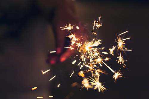 night person holding sparkler outdoors