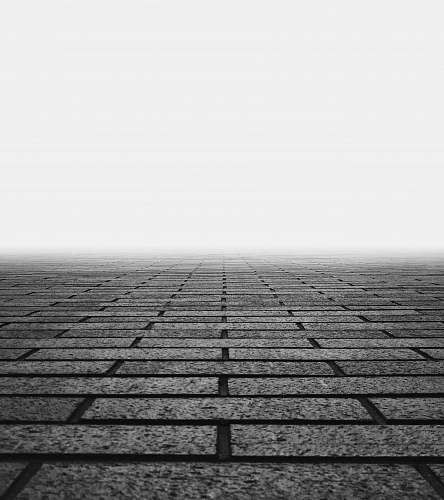 black-and-white photo of gray concrete floor with fogs wall