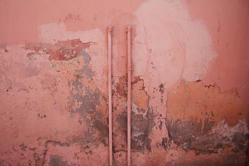 pink water hose on wall texture