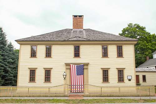 symbol brown wooden house with USA flag outside door american flag