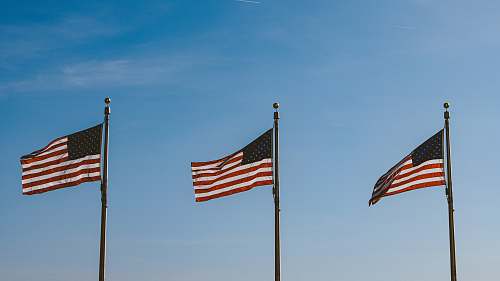 symbol three USA flags hanging on pole usa