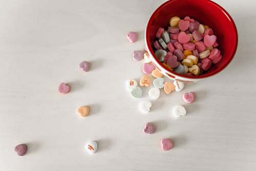 bean assorted-color candies and red and white ceramic bowl flora