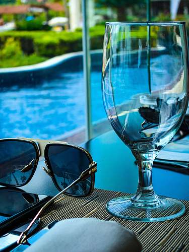 accessories empty goblet beside sunglasses sunglasses