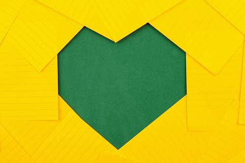 paper yellow papers forming green heart hole visit