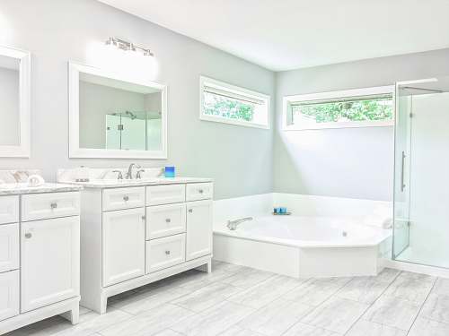 bathtub white ceramic bathtub near white wooden vanity sink tub