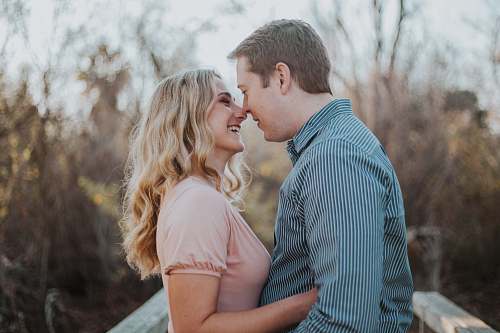 person man and woman standing while facing each other dating
