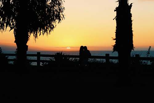 person silhouette of couple during sunset sunset