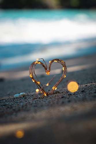 heart macro photography of heart shape sand decor fairy light
