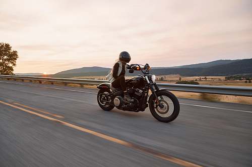 vehicle man on black cruiser motorcycle in highway transportation