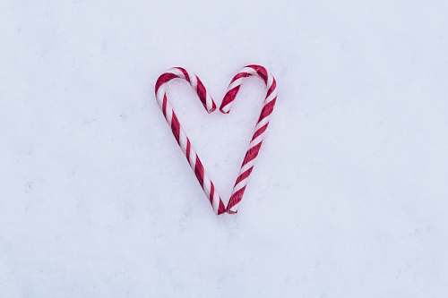 bomb two red-and-white candy canes on white surface dynamite