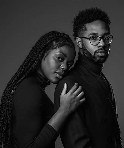 human grayscale photo of man and woman posing black-and-white