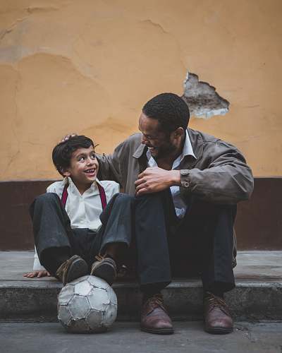 person man holding boy's head human