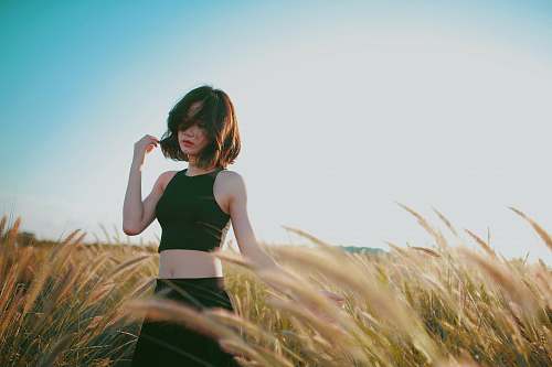 person woman on wheat field during daytime woman