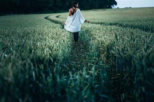 human woman walking on grass field woman