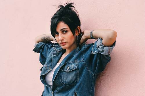woman Woman wearing a denim wall leaning against a millennial pink wall human