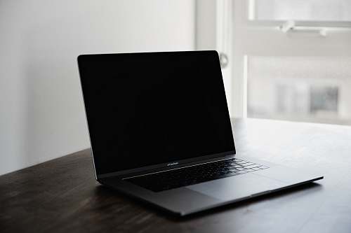  photo of black MacBook Pro on table 