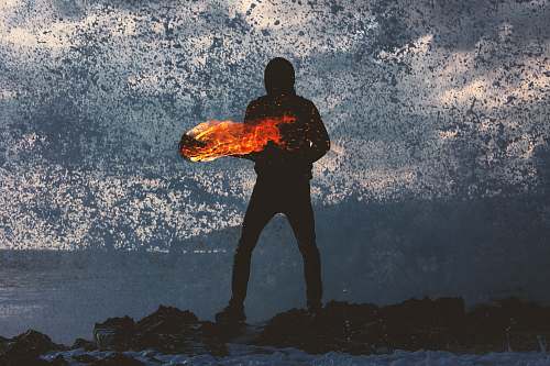 morocco silhouette of person standing holding torch fire