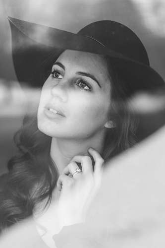 person grayscale photo of woman wearing sunhat portrait