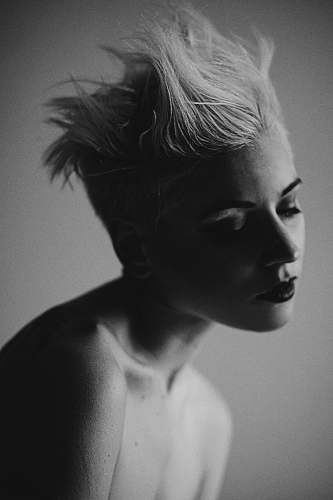 woman grayscale photography of woman with eyes closed hair
