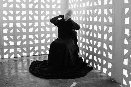 clothing mannequin wearing black dress sitting near cutout walls apparel