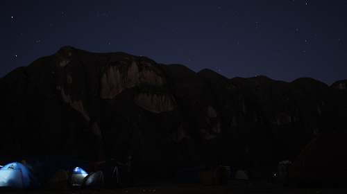 camping brown mountain at nighttime sky