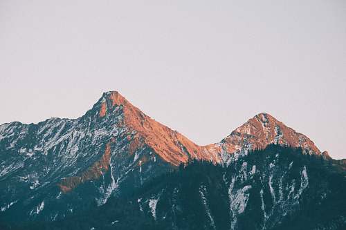 outdoors brown mountains under white sky mountain range